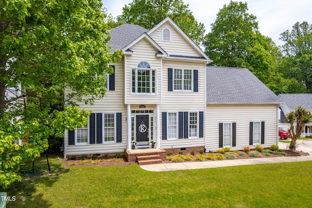 8600 Clivedon Dr, Raleigh, NC 27615 - colonial home featuring crawl space, roof with shingles, and a front lawn