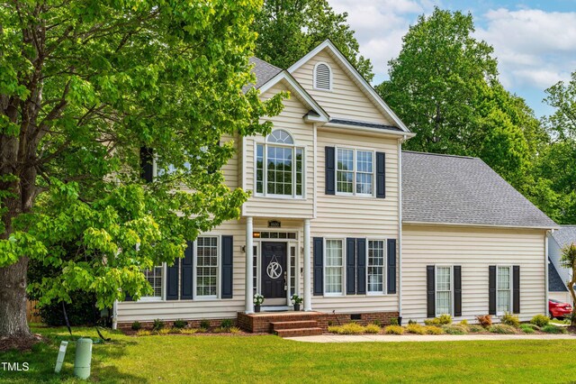 8600 Clivedon Dr, Raleigh, NC 27615 - view of front facade featuring crawl space, a shingled roof, and a front lawn