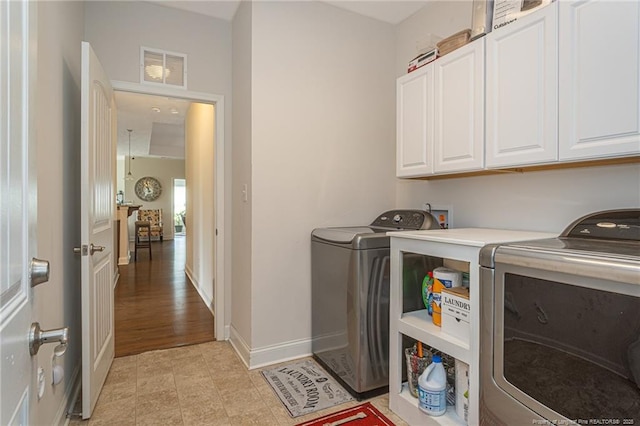 8220 Rivermist Ln, Linden, NC 28356 - clothes washing area featuring baseboards, cabinet space, washing machine and clothes dryer, and visible vents