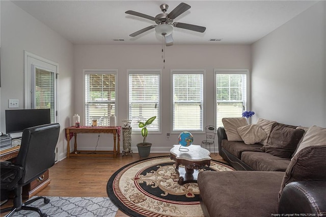 8220 Rivermist Ln, Linden, NC 28356 - living area featuring baseboards, visible vents, wood finished floors, and a ceiling fan