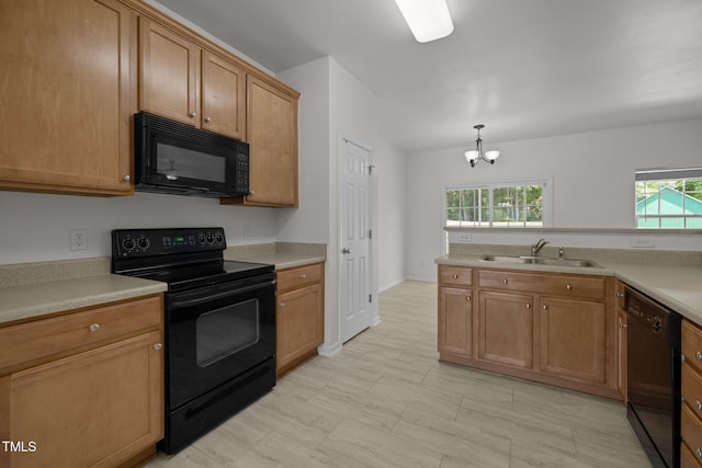 kitchen with decorative light fixtures, a sink, light countertops, black appliances, and an inviting chandelier