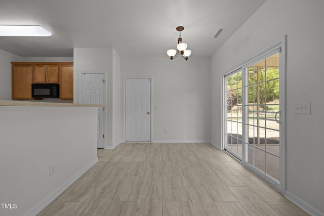 unfurnished dining area with baseboards, visible vents, and an inviting chandelier