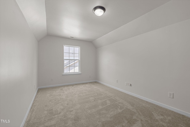 bonus room with baseboards, carpet flooring, vaulted ceiling, and visible vents