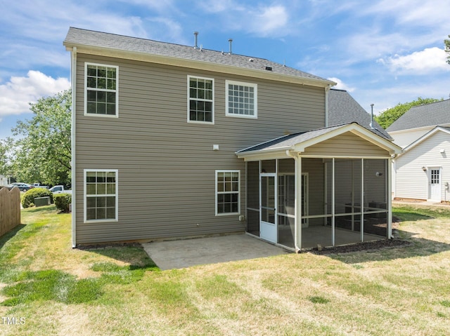 back of house featuring a lawn, a patio area, and a sunroom