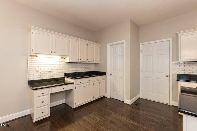 unfurnished office featuring baseboards and dark wood-style floors
