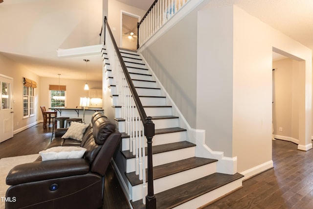 stairway featuring wood finished floors and baseboards