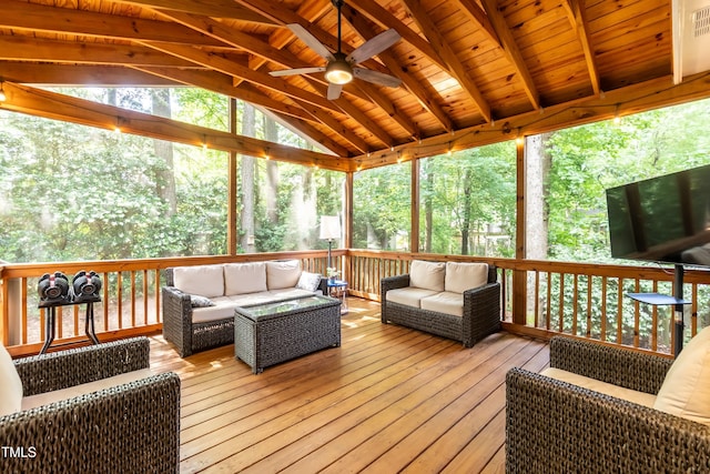 sunroom featuring lofted ceiling, an outdoor living space, and a ceiling fan