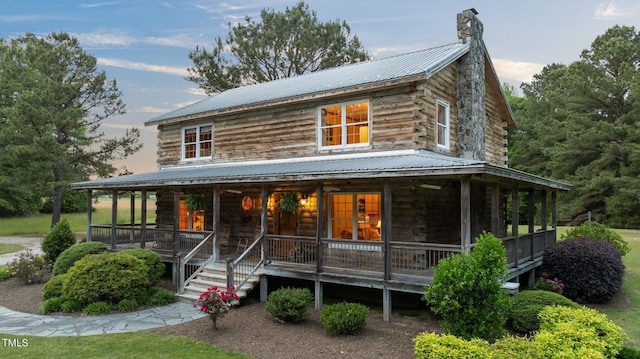 407 Howard Tant Rd, Zebulon, NC 27597 - view of front of property featuring a porch, log siding, metal roof, and a chimney