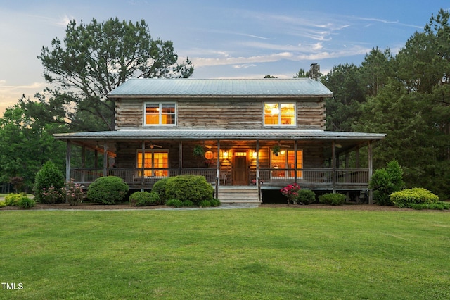 407 Howard Tant Rd, Zebulon, NC 27597 - view of front of home with covered porch, a lawn, and metal roof