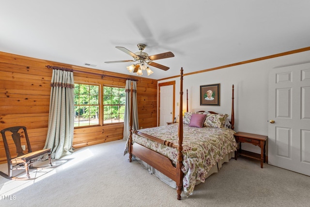 407 Howard Tant Rd, Zebulon, NC 27597 - bedroom featuring a ceiling fan, visible vents, light colored carpet, wood walls, and ornamental molding