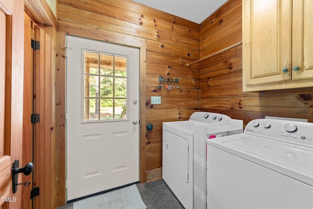 407 Howard Tant Rd, Zebulon, NC 27597 - laundry area with wood walls, cabinet space, and washer and clothes dryer