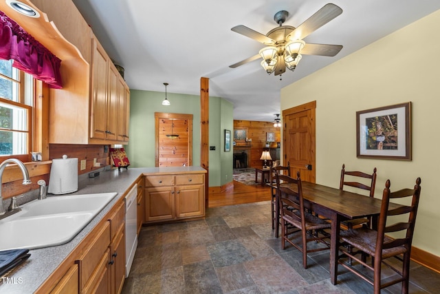 407 Howard Tant Rd, Zebulon, NC 27597 - kitchen with baseboards, ceiling fan, a sink, stone finish flooring, and dishwasher