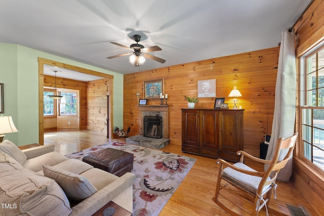 407 Howard Tant Rd, Zebulon, NC 27597 - living room featuring a ceiling fan, wood walls, and a wealth of natural light