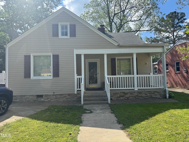 bungalow with covered porch, crawl space, and a front yard