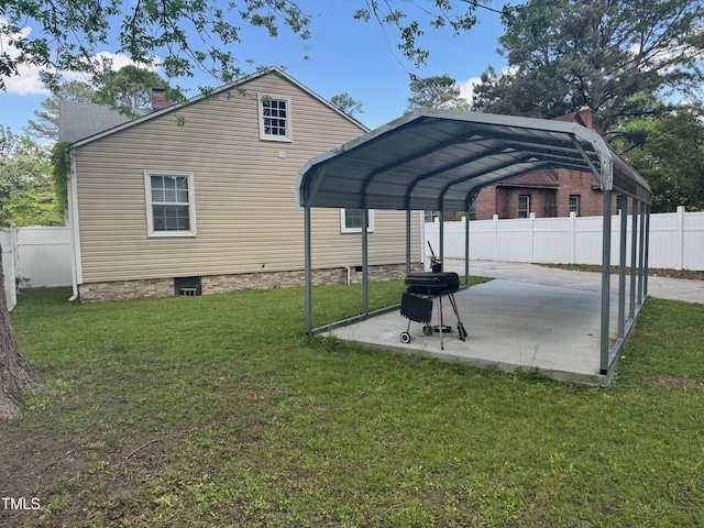 view of parking featuring a detached carport and fence