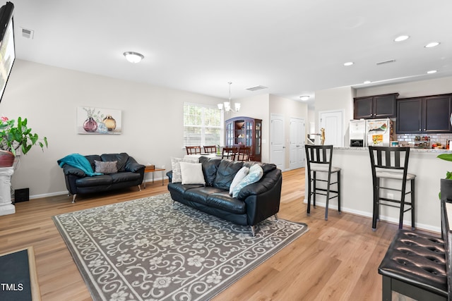 513 Commons Dr, Holly Springs, NC 27540 - living room featuring visible vents, an inviting chandelier, recessed lighting, and light wood finished floors