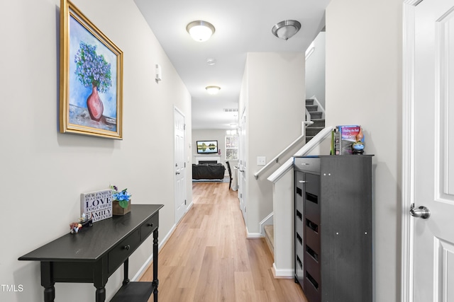 513 Commons Dr, Holly Springs, NC 27540 - corridor with light wood-style floors, baseboards, stairway, and visible vents