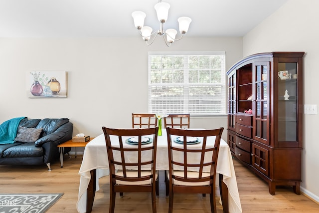513 Commons Dr, Holly Springs, NC 27540 - dining room featuring an inviting chandelier and light wood finished floors