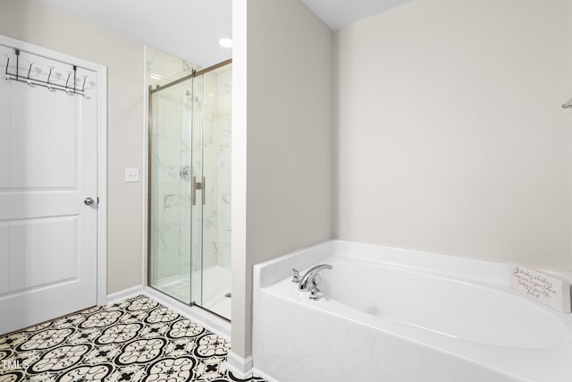 513 Commons Dr, Holly Springs, NC 27540 - bathroom featuring baseboards, a marble finish shower, and a bath