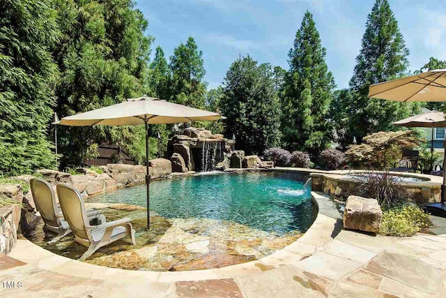 outdoor pool with a jacuzzi