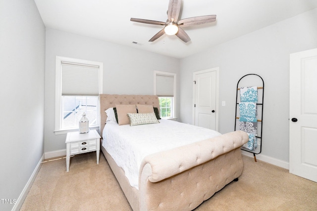 bedroom with light carpet, baseboards, and ceiling fan