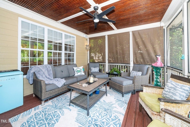 sunroom featuring a ceiling fan and an outdoor living space