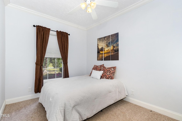 bedroom with baseboards, a ceiling fan, ornamental molding, and carpet floors
