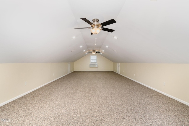 additional living space with baseboards, light carpet, ceiling fan, and vaulted ceiling