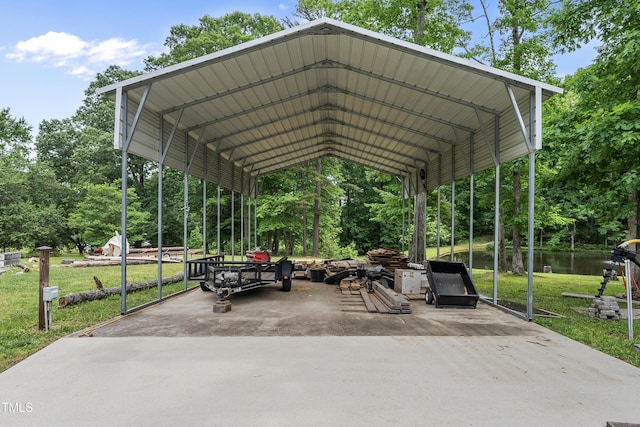 view of parking featuring a water view, driveway, and a carport