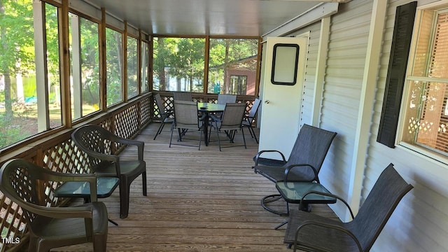 sunroom / solarium featuring plenty of natural light and outdoor dining space