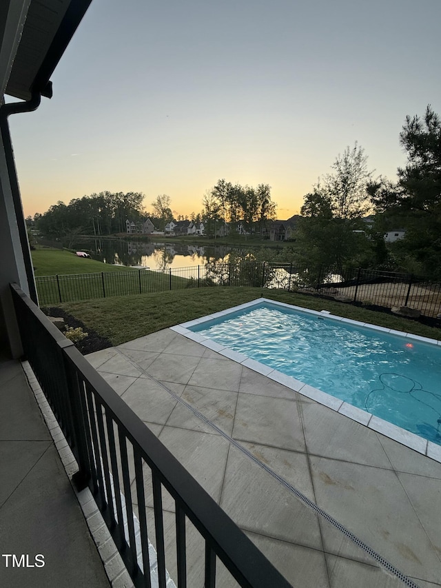 view of pool featuring a patio, a fenced in pool, a water view, a yard, and a fenced backyard