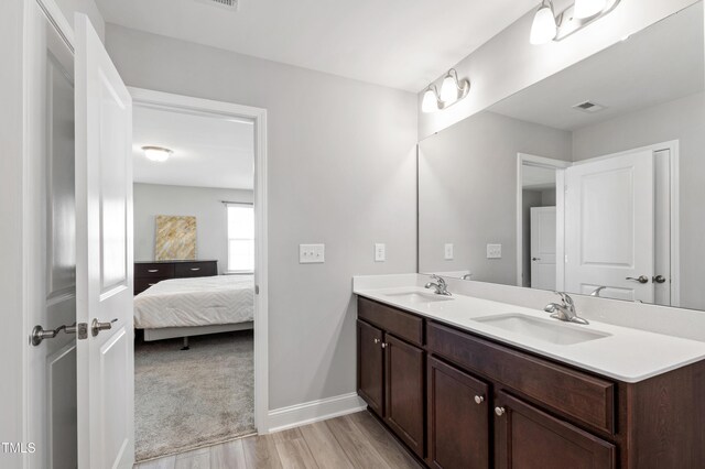 147 Antler Steel Dr, Clayton, NC 27527 - bathroom featuring visible vents, a sink, ensuite bath, and wood finished floors