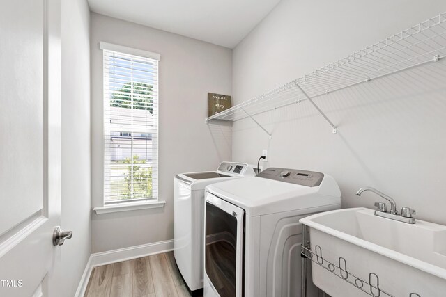 147 Antler Steel Dr, Clayton, NC 27527 - washroom featuring light wood-style floors, laundry area, independent washer and dryer, and a wealth of natural light