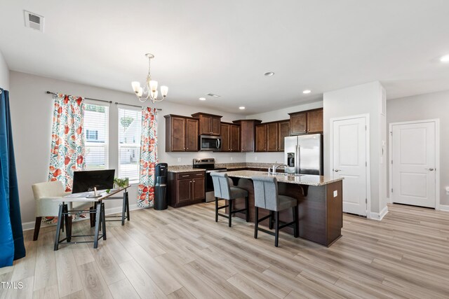 147 Antler Steel Dr, Clayton, NC 27527 - kitchen featuring dark brown cabinetry, appliances with stainless steel finishes, a chandelier, light wood-style flooring, and visible vents