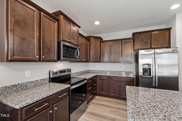 147 Antler Steel Dr, Clayton, NC 27527 - kitchen with light stone counters, recessed lighting, dark brown cabinets, and stainless steel appliances