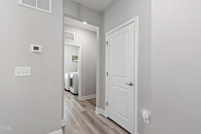 147 Antler Steel Dr, Clayton, NC 27527 - hall featuring separate washer and dryer, baseboards, light wood finished floors, and visible vents