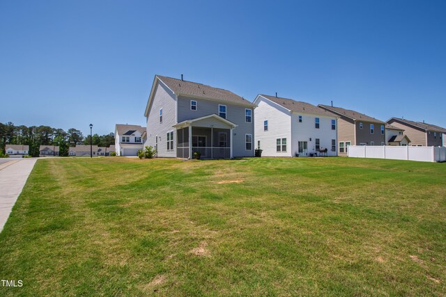 147 Antler Steel Dr, Clayton, NC 27527 - rear view of property with a lawn, fence, a residential view, and a sunroom