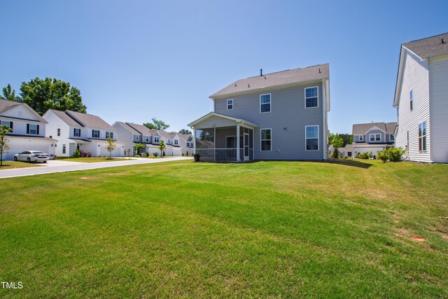 147 Antler Steel Dr, Clayton, NC 27527 - back of property featuring a residential view, a yard, and a sunroom