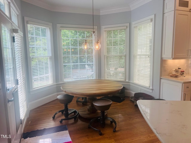 8729 Valentine Ct, Raleigh, NC 27613 - dining space featuring ornamental molding, wood finished floors, and baseboards