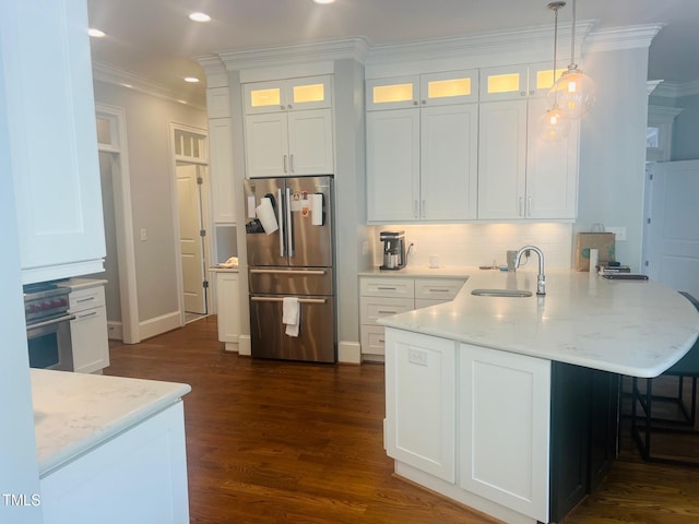 8729 Valentine Ct, Raleigh, NC 27613 - kitchen featuring stainless steel appliances, a sink, a peninsula, white cabinets, and ornamental molding