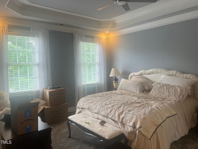 8729 Valentine Ct, Raleigh, NC 27613 - bedroom featuring a raised ceiling, crown molding, and a ceiling fan