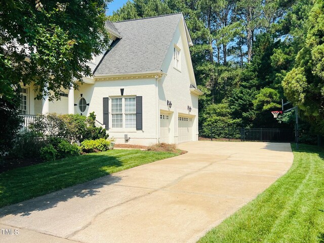 8729 Valentine Ct, Raleigh, NC 27613 - view of front facade with concrete driveway, an attached garage, a shingled roof, and brick siding