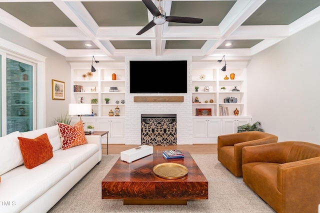 living area with a ceiling fan, beam ceiling, and built in shelves