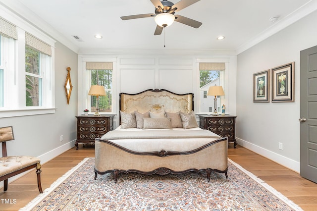 bedroom featuring baseboards, visible vents, ornamental molding, and light wood-style floors