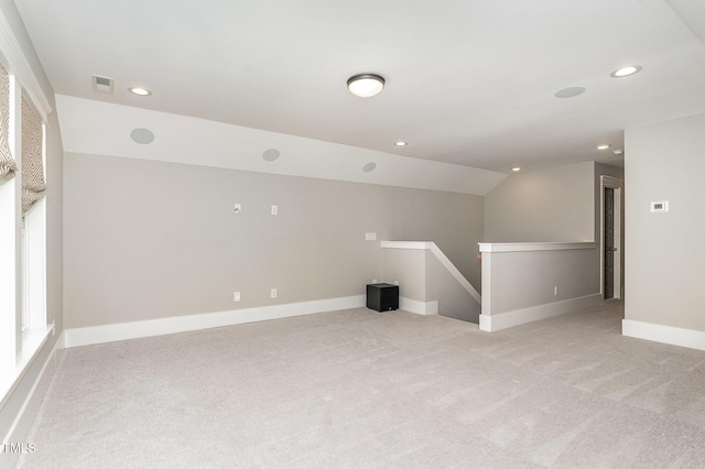 unfurnished room with baseboards, light carpet, recessed lighting, and visible vents