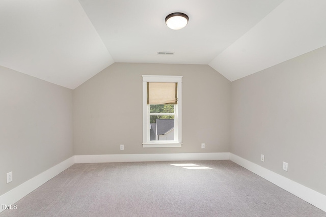 bonus room featuring baseboards, carpet flooring, lofted ceiling, and visible vents