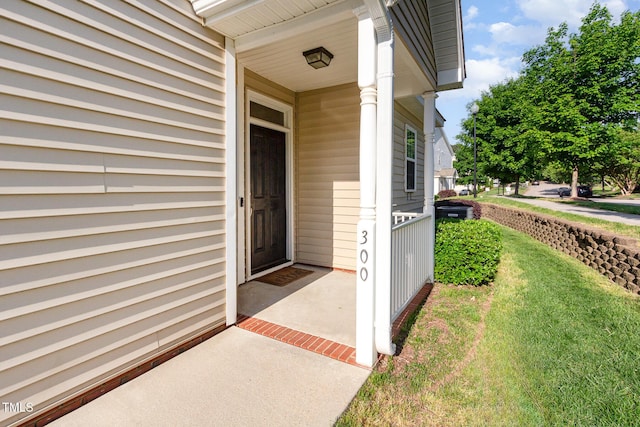 view of exterior entry featuring a porch
