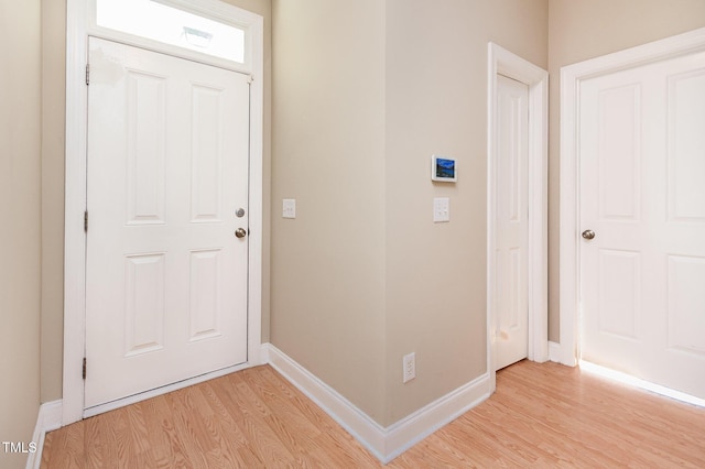 interior space with baseboards and light wood-style floors
