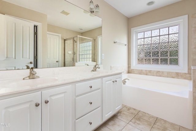 bathroom featuring a sink, tile patterned floors, a wealth of natural light, and a shower stall