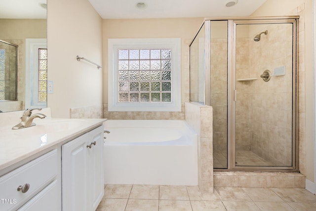 bathroom featuring tile patterned flooring, vanity, a healthy amount of sunlight, and a shower stall